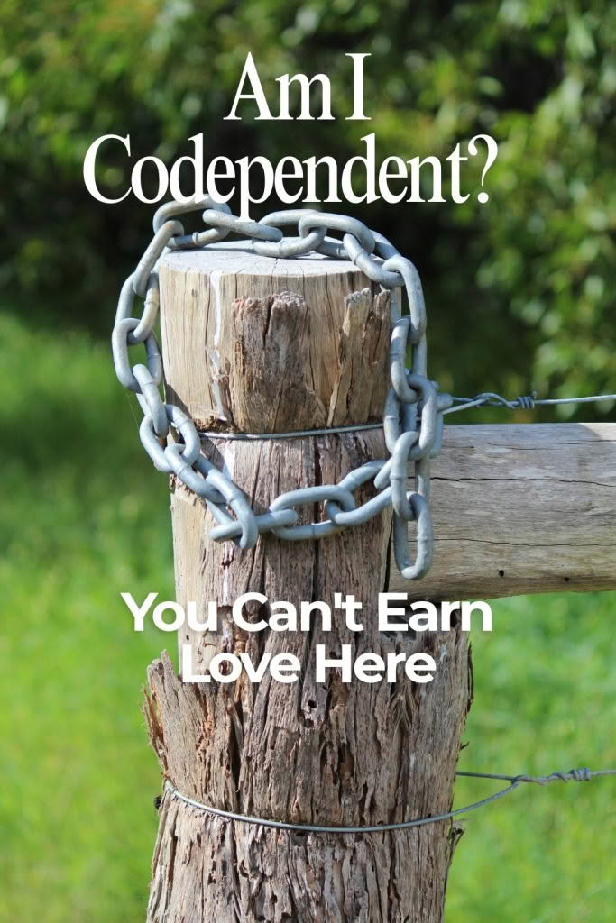 An image split into two halves. On the left, a light gray background features the text "Am I Codependent? You Can't Earn Love Here" in black, above a green spiral Celtic-style logo and the text "Turning The Page". On the right, a close-up shows a weathered wooden fence post tightly wrapped with a thick metal chain, set against a blurry green background of grass and foliage.